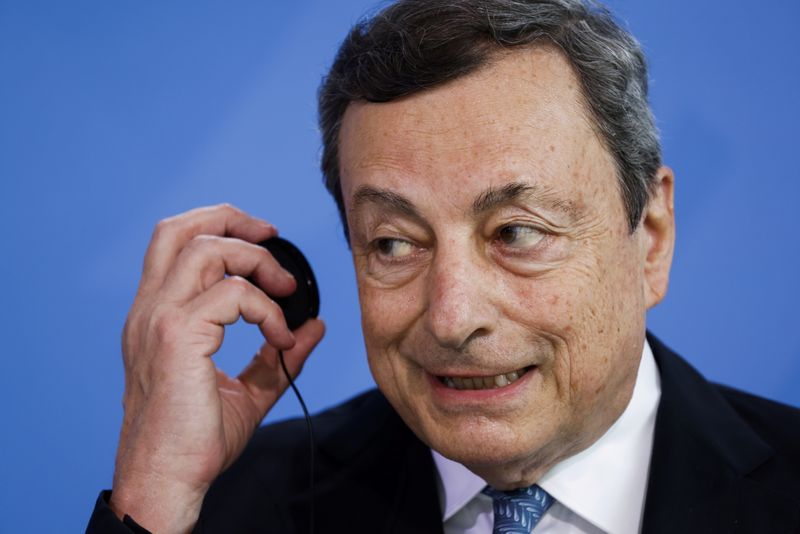 &copy; Reuters. Il premier Mario Draghi si toglie le cuffie dopo una conferenza stampa alla cancelleria di Berlino, Germania, 21 giugno 2021. Odd Andersen/Pool via REUTERS