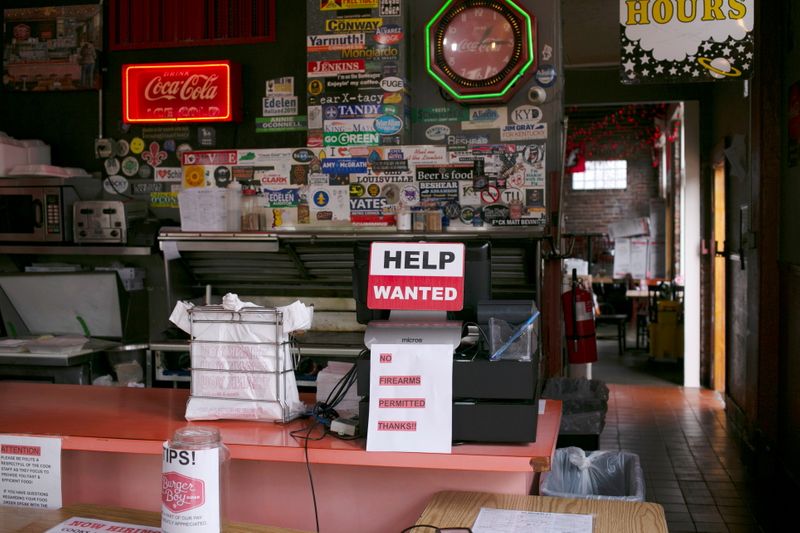 &copy; Reuters. A hiring sign is seen at the register of Burger Boy restaurant, as many restaurant businesses face staffing shortages in Louisville, Kentucky, U.S., June 7, 2021.  REUTERS/Amira Karaoud
