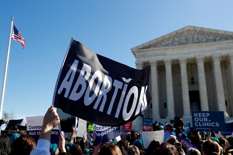 &copy; Reuters. FILE PHOTO: A demonstrator holds up an abortion flag outside of the U.S. Supreme Court as justices hear a major abortion case on the legality of a Republican-backed Louisiana law that imposes restrictions on abortion doctors, on Capitol Hill in Washington