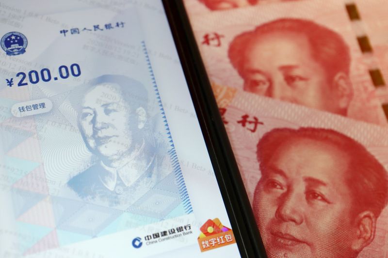 &copy; Reuters. FILE PHOTO: China's official app for digital yuan is seen on a mobile phone next to 100-yuan banknotes in this illustration picture taken October 16, 2020. REUTERS/Florence Lo/Illustration/File Photo