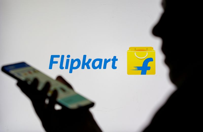 &copy; Reuters. FILE PHOTO: Woman with smartphone is seen in front of displayed Flipkart logo in this illustration taken, July 30, 2021. REUTERS/Dado Ruvic/Illustration