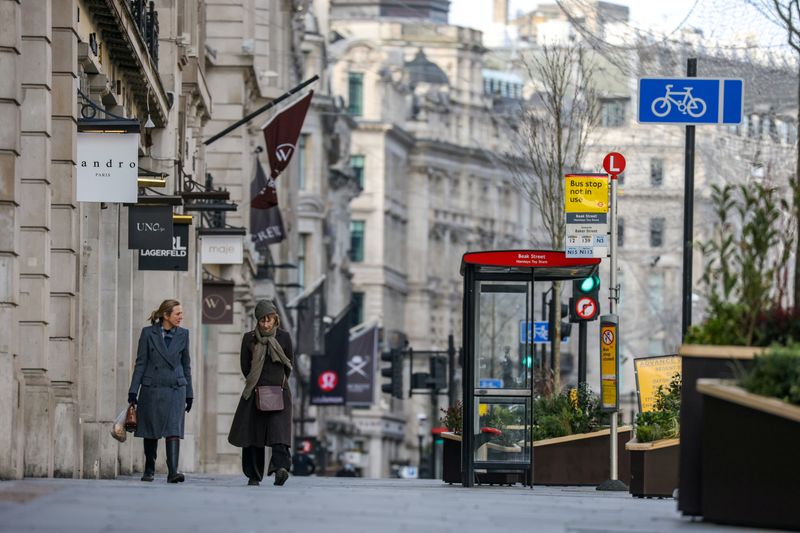 &copy; Reuters. FILE PHOTO: Two women walk down Regent Street, one of London's main shopping streets, January 17, 2021.   REUTERS/Kevin Coombs/File Photo