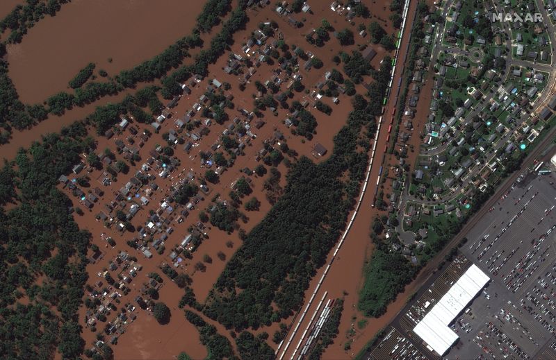 &copy; Reuters. FILE PHOTO: A satellite image shows a rail yard and homes along Huff Avenue submerged in floodwater after torrential rains swept through Manville, New Jersey, U.S., following the passing of Hurricane Ida, September 2, 2021. Satellite image copyright 2021 