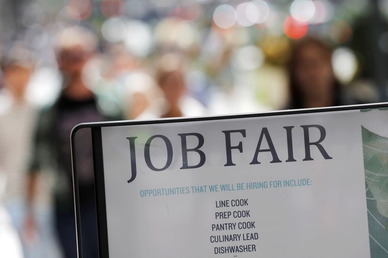 &copy; Reuters. FILE PHOTO: Signage for a job fair is seen on 5th Avenue after the release of the jobs report in Manhattan, New York City, U.S., September 3, 2021. REUTERS/Andrew Kelly