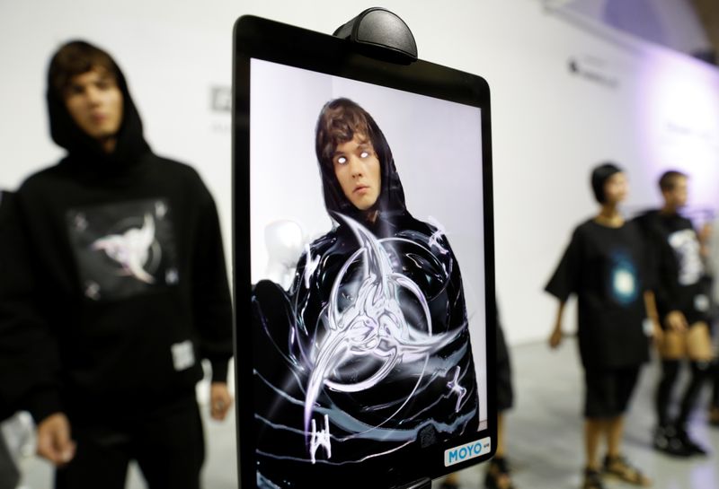 &copy; Reuters. Models present the collection of partially virtual clothing with elements of augmented reality designed by FINCH brand during Ukrainian Fashion Week in Kyiv, Ukraine September 4, 2021. Picture taken September 4, 2021.  REUTERS/Valentyn Ogirenko