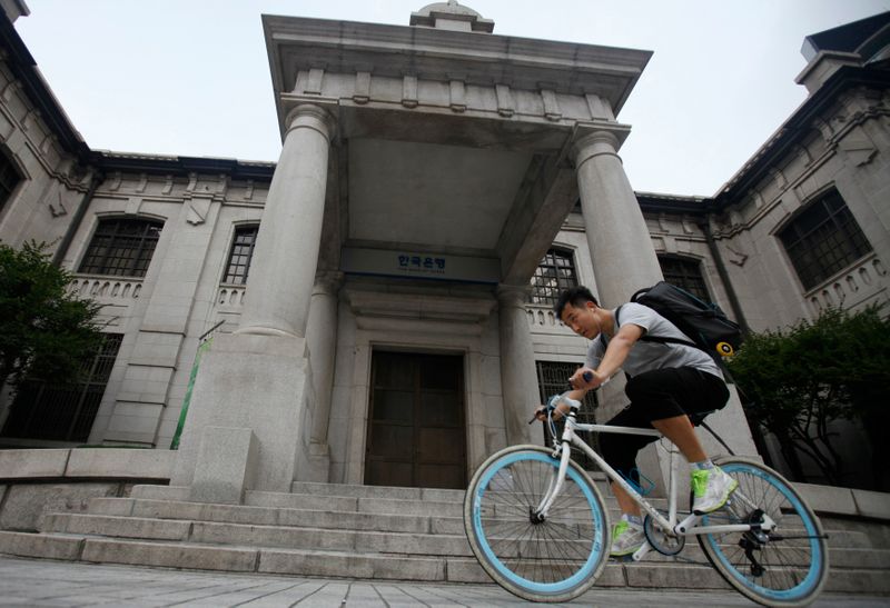 &copy; Reuters. FILE PHOTO: A man gets on a bicycle in front of the Bank of Korea in Seoul August 9, 2012. REUTERS/Kim Hong-Ji 