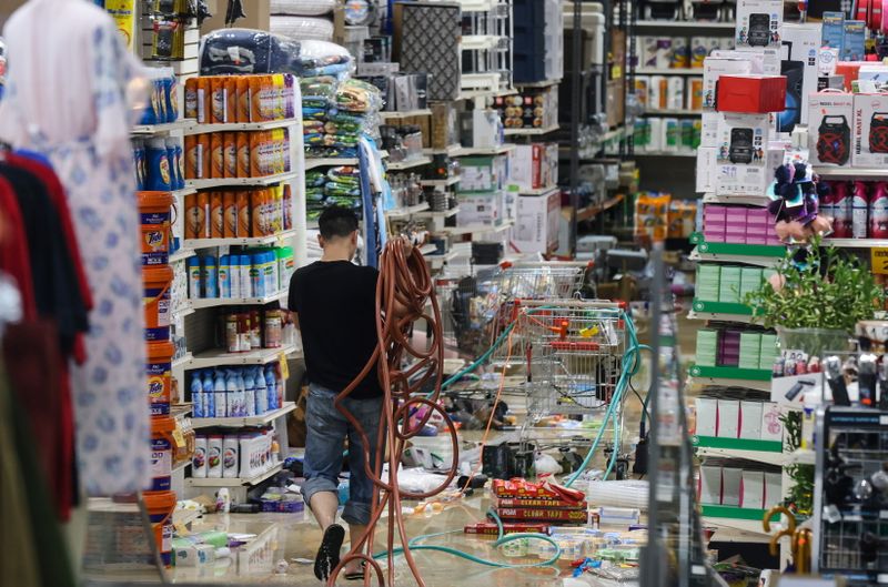 &copy; Reuters. A person works to clean up damage in a flooded store after the remnants of Tropical Storm Ida brought drenching rain and the threat of flash floods and tornadoes to parts of the northern mid-Atlantic, in the Bronx borough of New York City, U.S., September