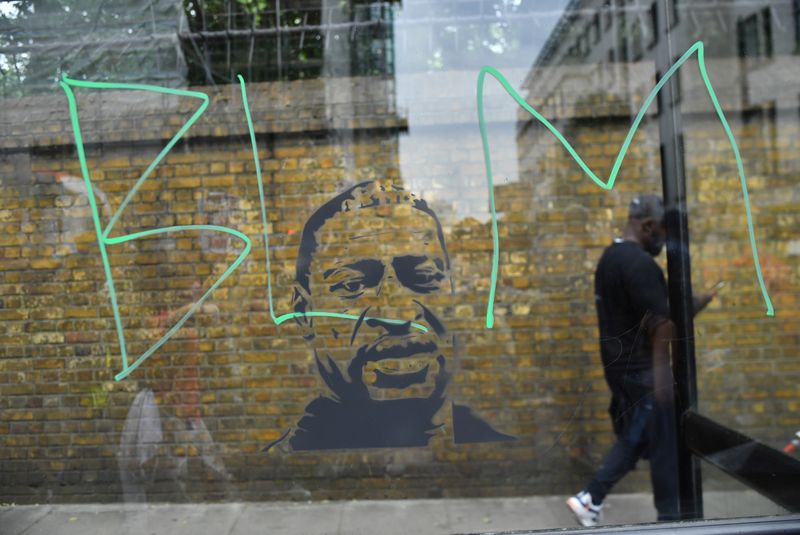 &copy; Reuters. The letters "BLM" are seen on a bus stop window in front of a mural of George Floyd during a "Black Lives Matter" protest following the death of George Floyd who died in police custody in Minneapolis, London, Britain, June 3, 2020. REUTERS/Dylan Martinez/