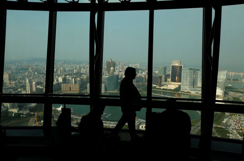© Reuters. FILE PHOTO: A visitor walks inside Macau Tower overlooking the skyline of Macau peninsula, China October 8, 2015. Picture taken October 8, 2015. REUTERS/Bobby Yip