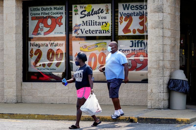 &copy; Reuters. FILE PHOTO: Shoppers leave a Piggly Wiggly supermarket with a sign honoring veterans in its window in Columbus, Georgia, U.S. September 8, 2020. REUTERS/Elijah Nouvelage/File Photo