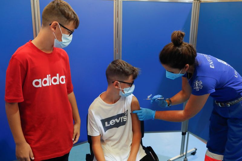 &copy; Reuters. طفل يتلقى جرعة لقاح فايزر-بيونتيك في إسبانيا. رويترز