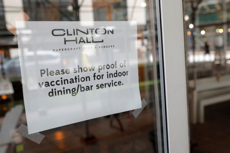 &copy; Reuters. Signage is seen on a window in a restaurant as the vaccine mandate commenced during the outbreak of the coronavirus disease (COVID-19) in Manhattan, New York City, U.S., August 17, 2021. REUTERS/Andrew Kelly