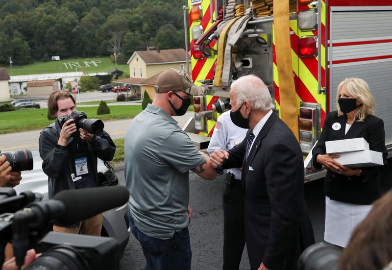 &copy; Reuters. Democratic U.S. presidential nominee and former Vice President Joe Biden elbow bumps a firefighter as he and his wife Jill deliver donuts and beer to firefighters at Shanksville fire station number 627 after visiting the nearby Flight 93 National Memorial