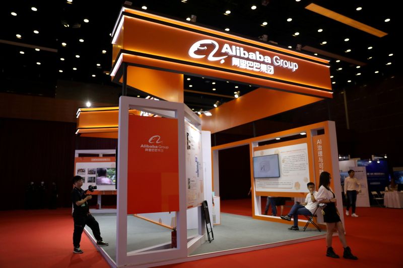 &copy; Reuters. FILE PHOTO: People are seen at a booth of Alibaba Group at an exhibition during China Internet Conference, in Beijing, China, July 13, 2021. REUTERS/Tingshu Wang