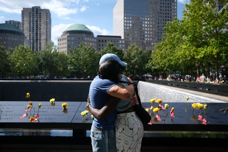 &copy; Reuters. People embrace as they visit the 9/11 Memorial on the 20th anniversary of the September 11, 2001 attacks in New York City, New York, U.S., September 11, 2021.  REUTERS/Amr Alfiky