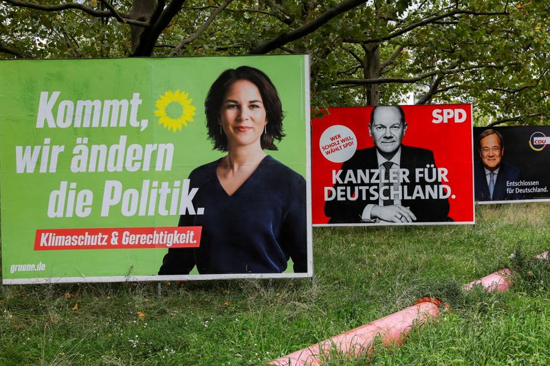 &copy; Reuters. FILE PHOTO: Election campaign billboards featuring the three top candidates for the German chancellery (the Greens' Annalena Baerbock, SPD's Olaf Scholz and CDU's Armin Laschet) stand on a roadside in Berlin, Germany, September 10, 2021. REUTERS/Michele T