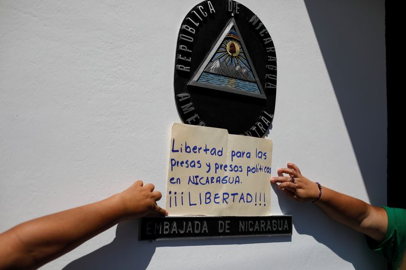 &copy; Reuters. FOTO DE ARCHIVO. Una mujer sostiene un cartel que pide libertad para los prisioneros políticos en Nicaragua, durante una protesta en El Salvador a fines del mes pasado. Junio 30, 2021. REUTERS/Jose Cabezas