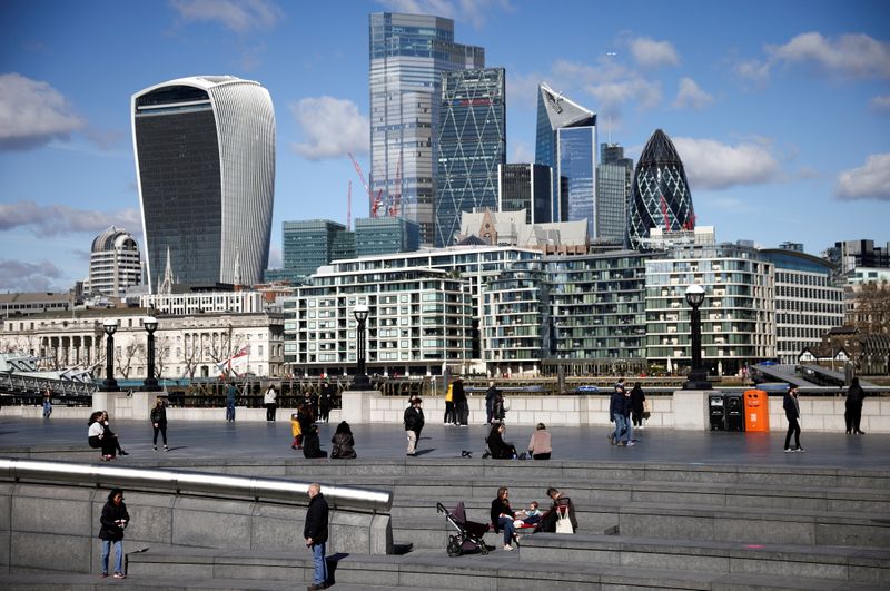 &copy; Reuters. FILE PHOTO: The City of London financial district can be seen as people walk along the south side of the River Thames, amid the coronavirus disease (COVID-19) outbreak in London, Britain, March 19, 2021. REUTERS/Henry Nicholls
