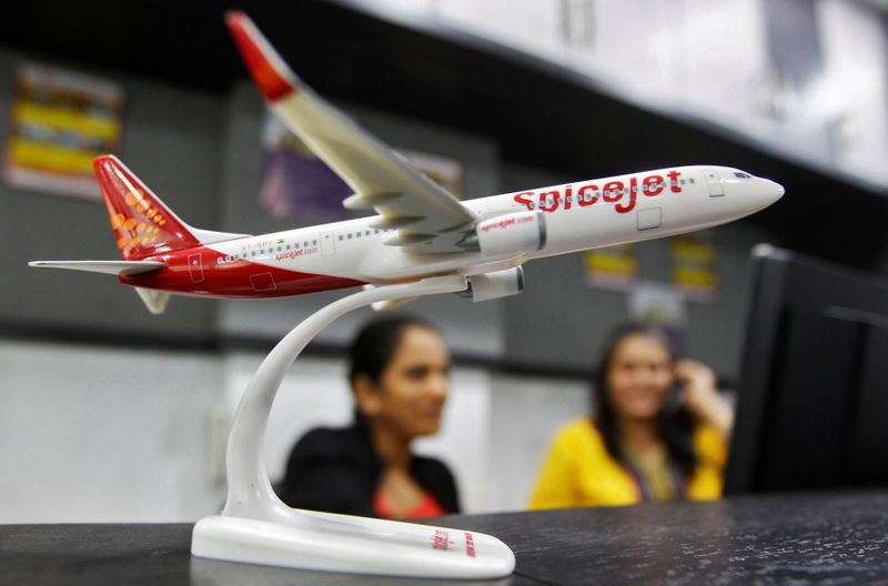 &copy; Reuters. FILE PHOTO: Employees work inside a travel agency office beside a model of a SpiceJet aircraft in the western Indian city of Ahmedabad February 14, 2014. REUTERS/Amit Dave/File Photo