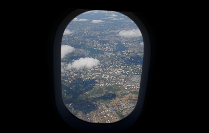 © Reuters. An aerial view of Moscow is seen from an Aeroflot airplane after taking off at Moscow's Sheremetyevo airport, Russia, June 17, 2018. As well as shooting all the matches, Reuters photographers are producing pictures showing their own quirky view from the sidelines of the World Cup.   REUTERS/Toru Hanai