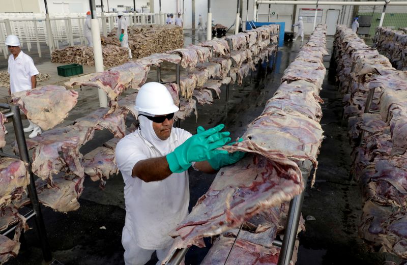 &copy; Reuters. FILE PHOTO: A worker spreads salted meat which will be dried and then packed at a plant of JBS S.A, the world's largest beef producer, in Santana de Parnaiba, Brazil December 19, 2017. REUTERS/Paulo Whitaker/File Photo