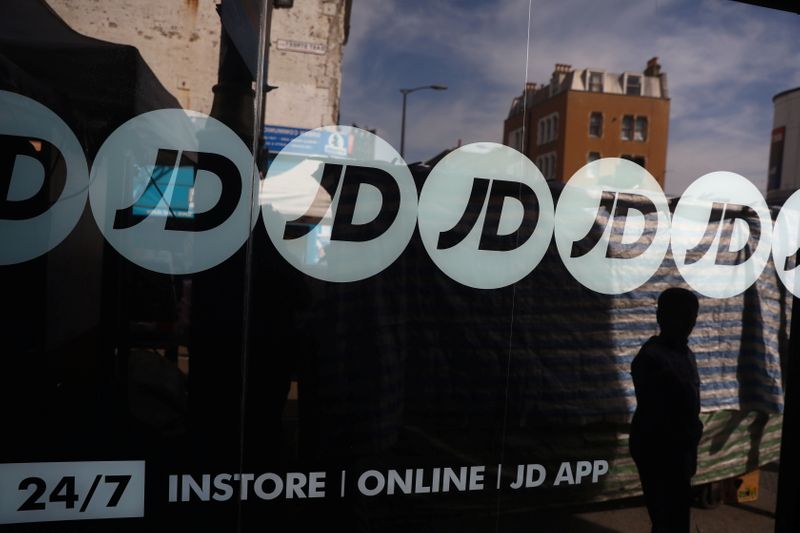 &copy; Reuters. FILE PHOTO: People pass a JD Sports store in London, Britain April 11, 2017.   REUTERS/Neil Hall/File Photo  GLOBAL BUSINESS WEEK AHEAD