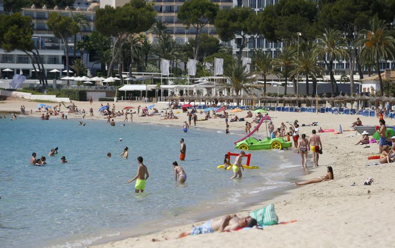 &copy; Reuters. FILE PHOTO: People enjoy themselves at Magaluf beach in Mallorca as British tourists are expected to resume travels to the area starting from June 30th, Spain, June 29, 2021. REUTERS/Enrique Calvo/File Photo