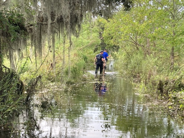 © Reuters. Sgt. Devin Coulon and Cpl. Chance Woods of the St. Tammany Parish Sheriff's Office searching for an alligator believed to have killed a man after Hurricane Ida in Slidell, Louisiana, in this handout picture obtained by Reuters on September 14, 2021. St. Tammany Parish Sheriff's Office/Handout via REUTERS  