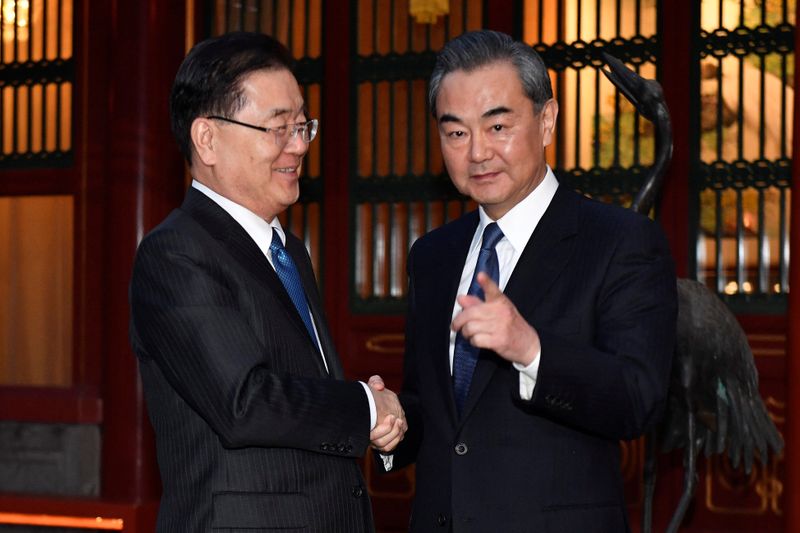 &copy; Reuters. FILE PHOTO: South Korean National Security Director, Chung Eui-yong (L) shakes hands with Chinese Foreign Minister, Wang Yi (R) before their meeting at Diaoyutai State Guesthouse in Beijing, China March 12 2018. REUTERS/Kenzaburo Fukuhara/Pool