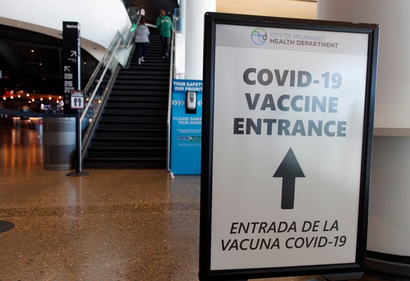 &copy; Reuters. 　米スポーツ専門局ＥＳＰＮは１４日、ＮＢＡ選手への新型コロナウイルスのワクチン接種は義務化されない見通しと報じた。写真はワクチン接種場所を指示する看板。米ウィスコンシン州