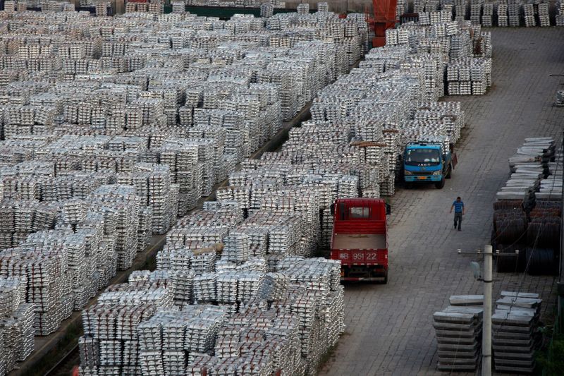 &copy; Reuters. FILE PHOTO: A worker walks through an aluminium ingots depot in Wuxi, Jiangsu province September 26, 2012. REUTERS/Aly Song/File Photo