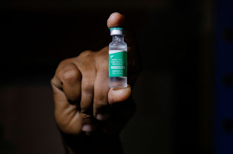 &copy; Reuters. FILE PHOTO: A man displays a vial AstraZeneca's COVISHIELD vaccine as the country receives its first batch of coronavirus disease (COVID-19) vaccines under COVAX scheme, in Accra, Ghana February 24, 2021. REUTERS/Francis Kokoroko/File Photo