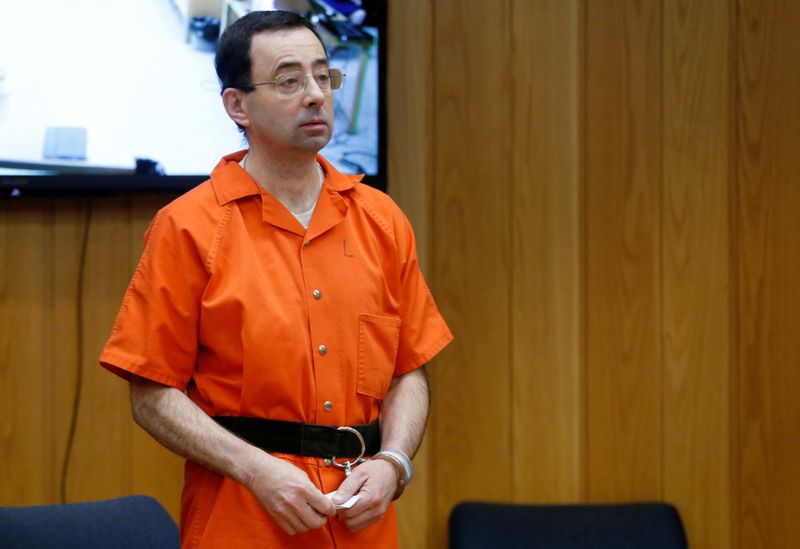&copy; Reuters. Larry Nassar, a former team USA Gymnastics doctor who pleaded guilty in November 2017 to sexual assault charges, stands in court during his sentencing hearing in the Eaton County Court in Charlotte, Michigan, U.S., February 5, 2018.  REUTERS/Rebecca Cook