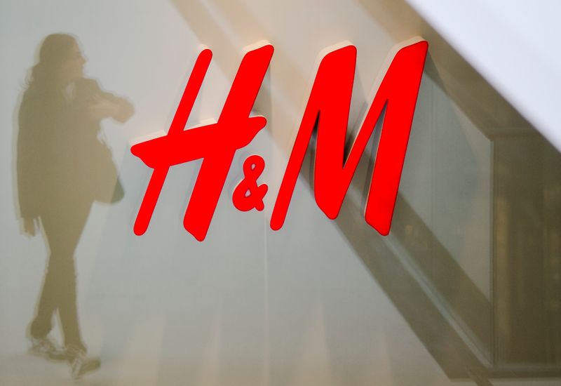 &copy; Reuters. A woman is reflected next to the logo of the H&M fashion retailer in the newly opened Mall of Berlin shopping centre in Berlin, September 25, 2014. A gigantic German department store rebuilt in the heart of Berlin on the rubble of pre-war Europe's most fa