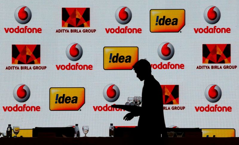&copy; Reuters. FILE PHOTO: A hotel employee clears a table after Vodafone Group and Idea Cellular news conference in Mumbai, India March 20, 2017. REUTERS/Danish Siddiqui/File Photo