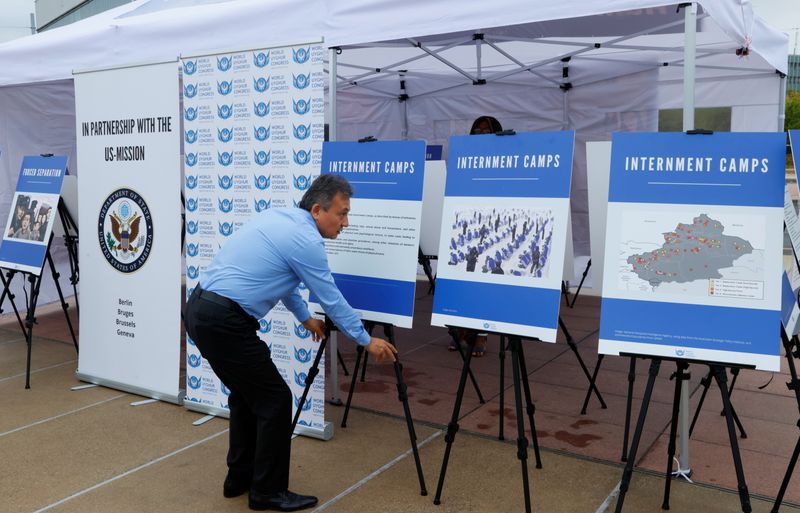 &copy; Reuters. Dolkun Isa, President of the World Uyghur Congress sets up the display at a United States-backed Uyghur photo exhibit of dozens of people who are missing or alleged to be held in Chinese-run camps in Xinjiang, China in front of the United Nations in Genev