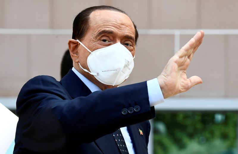 &copy; Reuters. FILE PHOTO: Former Italian Prime Minister Silvio Berlusconi gestures as he is discharged from Milan's San Raffaele hospital, where he was being treated after testing positive for the coronavirus disease (COVID-19) and diagnosed with mild pneumonia, in Mil
