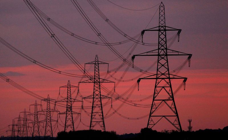 &copy; Reuters. FILE PHOTO: The sun rises behind electricity pylons near Chester, northern England October 24, 2011.  REUTERS/Phil Noble//File Photo