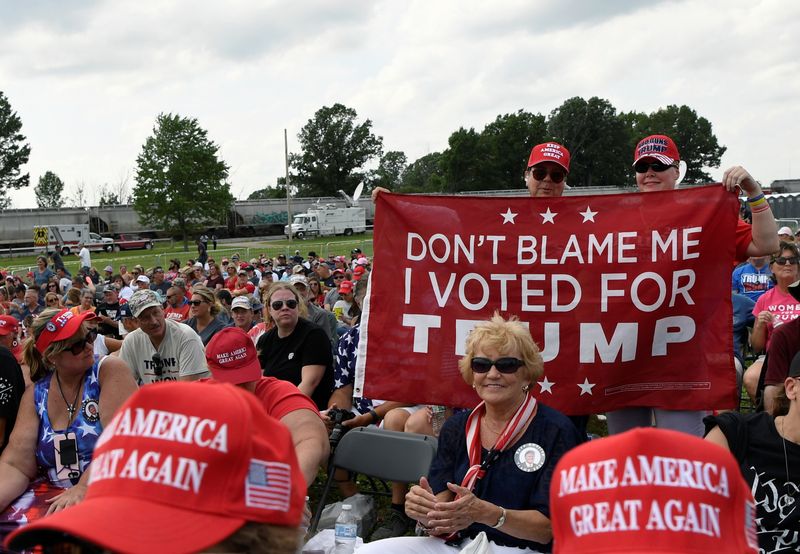 &copy; Reuters. FILE PHOTO: Supporters of former U.S. President Donald Trump hold a banner during his first post-presidency campaign rally at the Lorain County Fairgrounds in Wellington, Ohio, U.S., June 26, 2021. REUTERS/Gaelen Morse