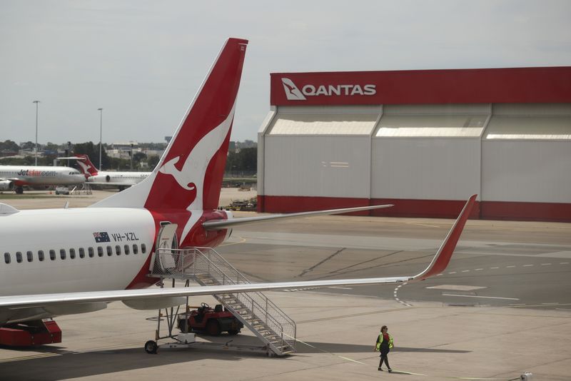 &copy; Reuters. FILE PHOTO: A crew member walks from a Qantas plane at a domestic terminal at Sydney Airport in Sydney, Australia, November 16, 2020.  REUTERS/Loren Elliott/File Photo  GLOBAL BUSINESS WEEK AHEAD