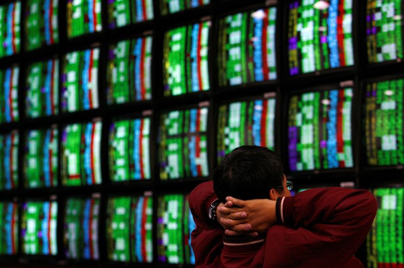 &copy; Reuters. FILE PHOTO: A man looks at stock market monitors in Taipei January 22, 2008. REUTERS/Nicky Loh/File Photo