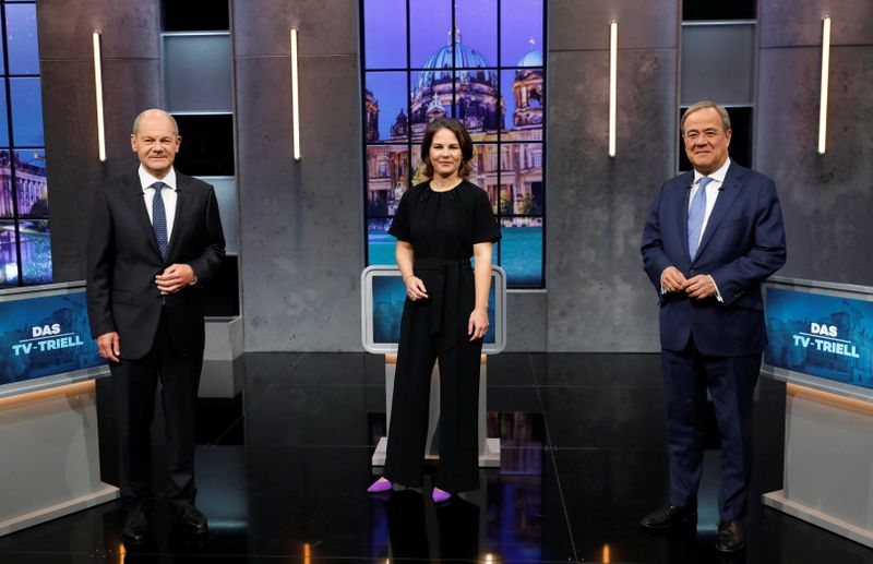© Reuters. Candidates for the Federal elections Armin Laschet, CDU, Olaf Scholz, SPD and Annalena Baerbock, Greens pose for a photo, ahead of a TV talk show, in Berlin, Germany, September 19, 2021. REUTERS/Michele Tantussi