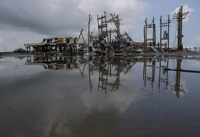 &copy; Reuters. FILE PHOTO: Damaged power lines and homes can be seen days after hurricane Ida ripped through Grand Isle, Louisiana, U.S., September 2, 2021. REUTERS/Leah Millis//File Photo