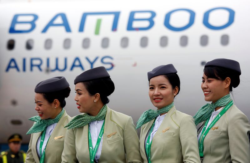 &copy; Reuters. FILE PHOTO: Crew members stand near an Airbus A321 aircraft of Bamboo Airways before a flight at Noi Bai airport in Hanoi, Vietnam January 16, 2019. REUTERS/Kham