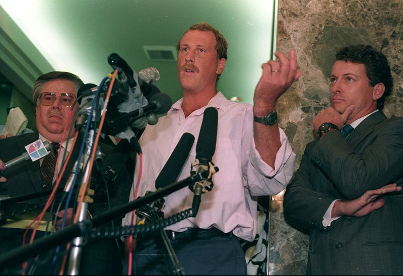 © Reuters. FILE PHOTO: Amateur cameraman George Holliday (C), who captured the beating of Rodney King by Los Angeles Police officers on videotape March 3, and his attorney James Jordan face reporters during a June 5 press conference announcing a $100 million lawsuit against all television stations which broadcast his tape in violation of federal copyright laws. Holliday claims that although he agreed to have the tape aired on local station KTLA, he was unaware that it would be distributed to national networks such as CNN. REUTERS/Lee Celano  LC/File Photo