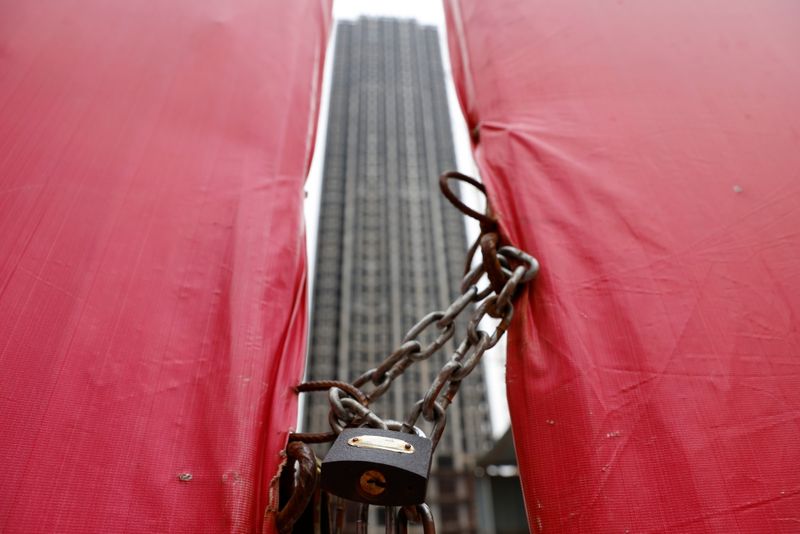 © Reuters. An unfinished residential building is pictured through a construction site gate at Evergrande Oasis, a housing complex developed by Evergrande Group, in Luoyang, China September 16, 2021. Picture taken September 16, 2021. REUTERS/Carlos Garcia Rawlins