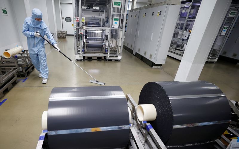 &copy; Reuters. FILE PHOTO: A worker in a protective suit sweeps the floor inside the Envision battery manufacturing plant at Nissan's Sunderland factory, Britain, July 1, 2021. REUTERS/Phil Noble