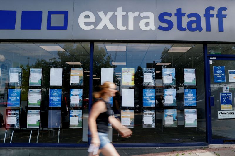 &copy; Reuters. FILE PHOTO: A woman walks past an employment agency "ExtraStaff" in North London, amid the spread of the coronavirus disease (COVID-19), in London, Britain June 16, 2020. REUTERS/John Sibley