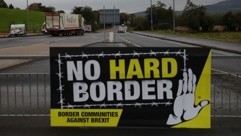 &copy; Reuters. A lorry drives past a 'No Hard Border' poster near Londonderry, Northern Ireland October 15, 2019. Picture taken October 15, 2019. REUTERS/Phil Noble
