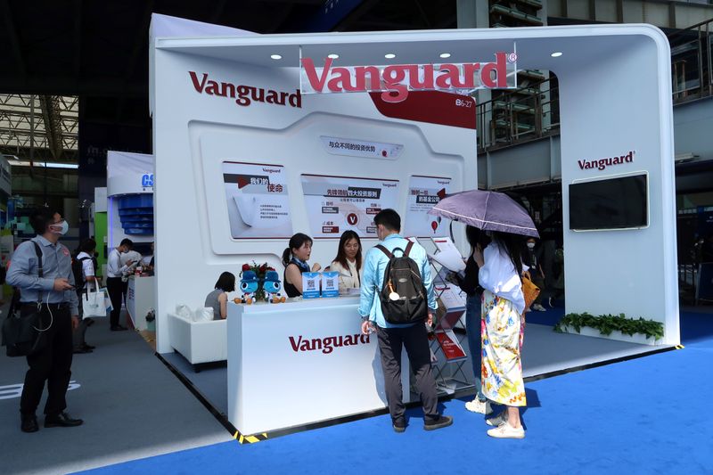 &copy; Reuters. FILE PHOTO: People are seen at a booth of Vanguard Group at a fair during the INCLUSION fintech conference in Shanghai, China September 24, 2020. REUTERS/Cheng Leng
